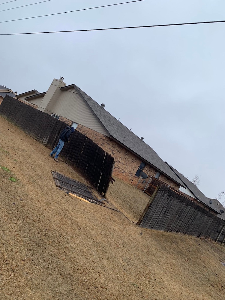Before — Leaning, worn wood fence at an Oklahoma property