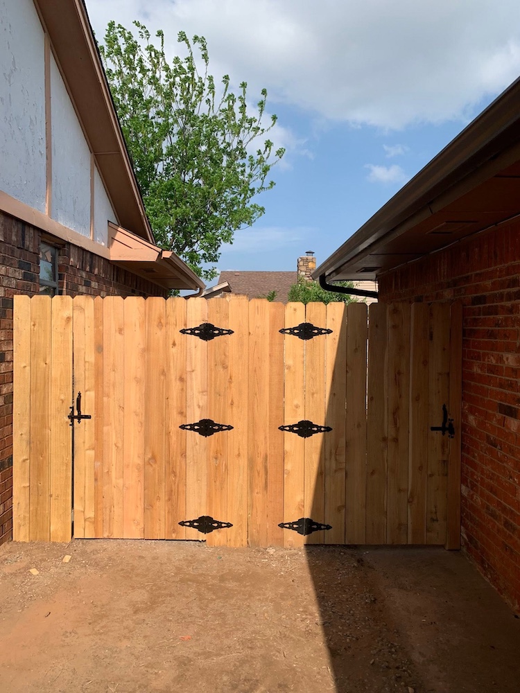 Fence contractor work along a residential property line in Oklahoma