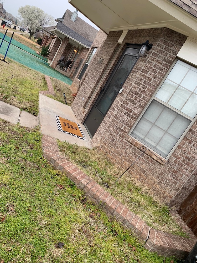 Before — Bare, unfinished strip along a brick exterior wall