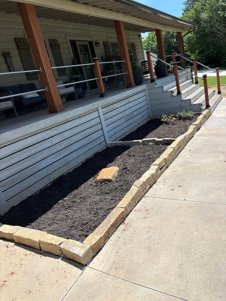 After — Clean edged bed and fresh mulch along the same walkway